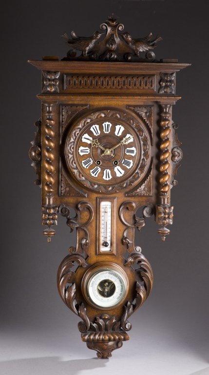 Carved Black Forest style wall clock.: A Black Forest style wall clock with barometer and thermometer. Late 19th century. There are two carved birds at top with turned finials and spiral turnings on the side. 35" h x 16" w x 4 1/2" d.