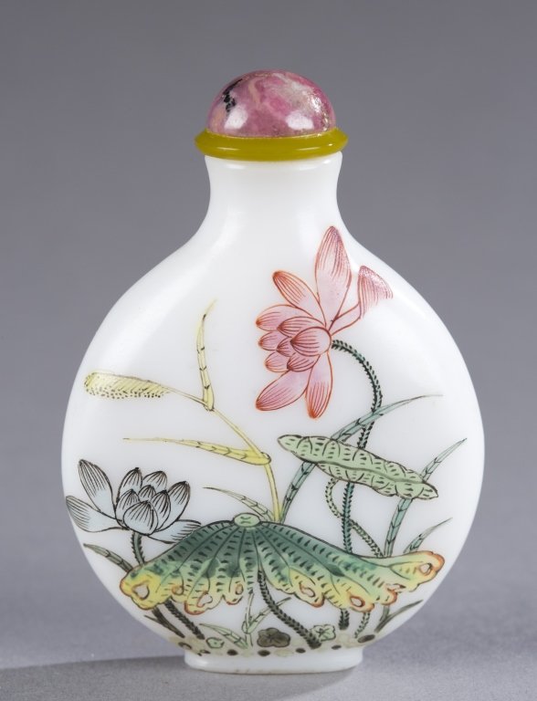 Enamel on milk glass 18th century snuff bottle.: A Chinese enamel on milk glass snuff bottle. 18th century. Of flattened round form with flowering lotus on the front. Marked with Gu Yue Xuan 3-character mark. 2 3/8"h. Provenance: Ex of the Claar col