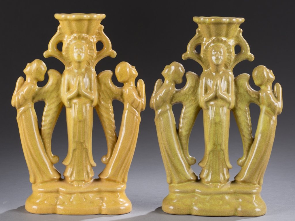 A Cowan Pottery pair of Byzantine candlestick holders.: A Cowan Pottery pair of Byzantine candlestick holders. c. 1927. Green rutile glaze. Impressed Cowan mark on bottom. 9"h x 5"w. Condition: Crack on bottom of greener candleholder.