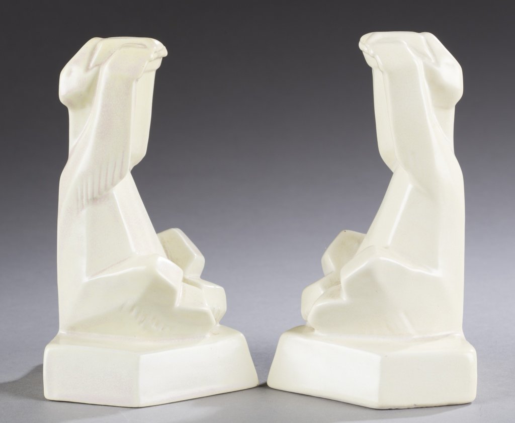 A Cowan Pottery pair of Polar bear bookends: A Cowan Pottery pair of Polar bear bookends attributed to Margaret Postgate. c. 1929-1930. Ivory. Unmarked. Both: 6"h x 3 3/8"w. Condition: Hair line fracture on bottom of piece as seen in second phot