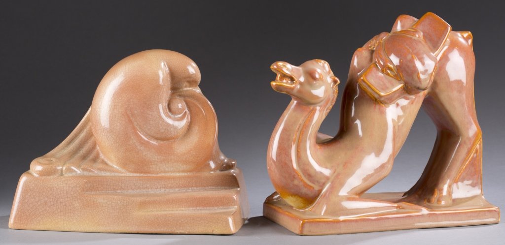 A Cowan Pottery Modern Madonna figure and camel: A Cowan Pottery Modern Madonna figure and camel bookend by Margret Postgate and Alexander Blazys.c. 1929.Terracotta. Unmarked. 6 1/2"h x 9"w. ++ Blazys camel bookend, 748. c. 1930. Russet Brown. Impre