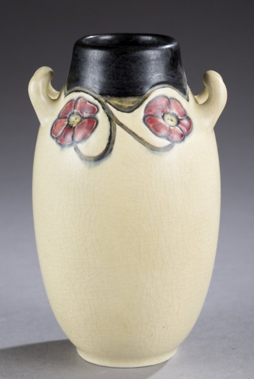 A Rookwood double handled vase by Charles S. Todd.: A Rookwood double handled vase by Charles S. Todd. 1917. Matte glaze vase with floral design and black top. Impressed on bottom, Rookwood stamp, XVII, 77C and artist mark. 5 1/2". Condition: Crazing t