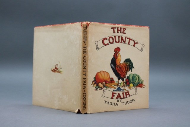 Tasha Tudor. THE COUNTY FAIR. (1940). 1st ed., dj.: [Children's]. Tasha Tudor. THE COUNTY FAIR. London New York Toronto: Oxford University Press, (1940). 4 ¾ x 4 in. [52]pp. Red cloth with white polka dots, blue lettered title and author within scallo