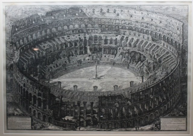 Veduta Dell'Anfiteatro Flavio Detto Il Colosseo.: [Piranesi, Francesco]. Veduta Dell’Anfiteatro Flavio Detto Il Colosseo. Engraving of the Coliseum, with 12 locations labeled in panels at lower left and lower right. At lower right: “Cav. Piranesi