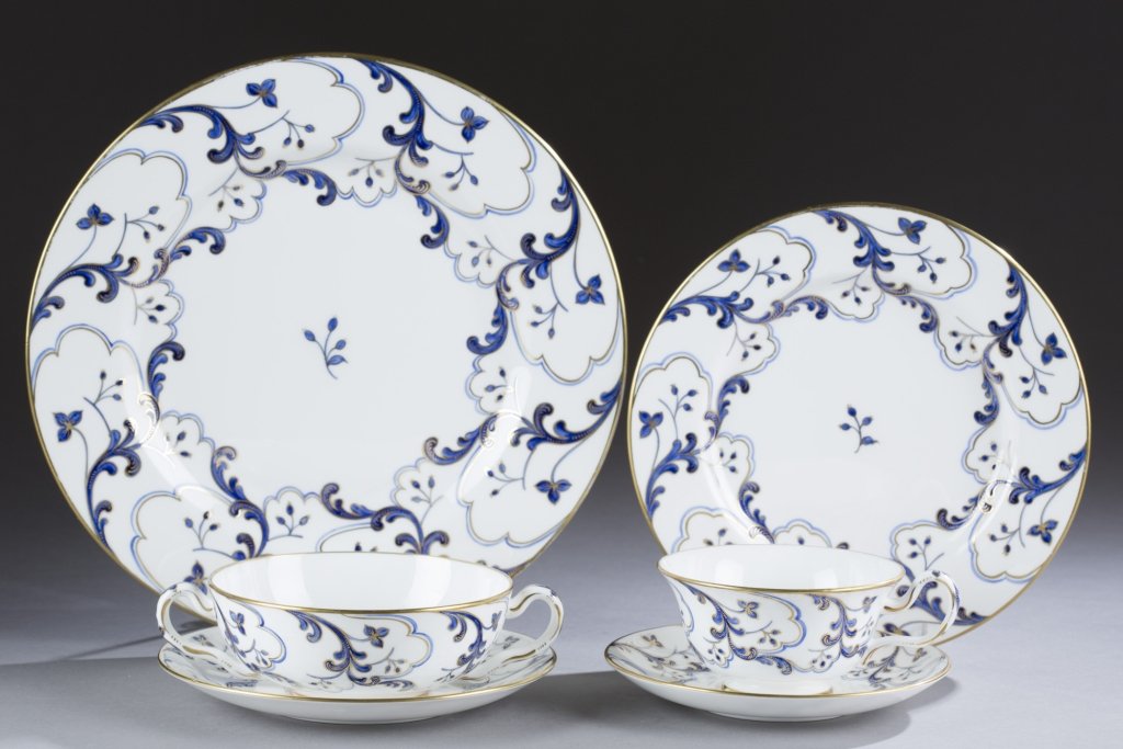 Tiffany & Co. private stock dinner set.: A Tiffany & Co. private stock porcelain dinnerware service for 12. c.1960. Decorated by Camille Le Tallec (1906-1991), Paris. A flourishing floral motif with berries in gold and royal blue. Signed on 