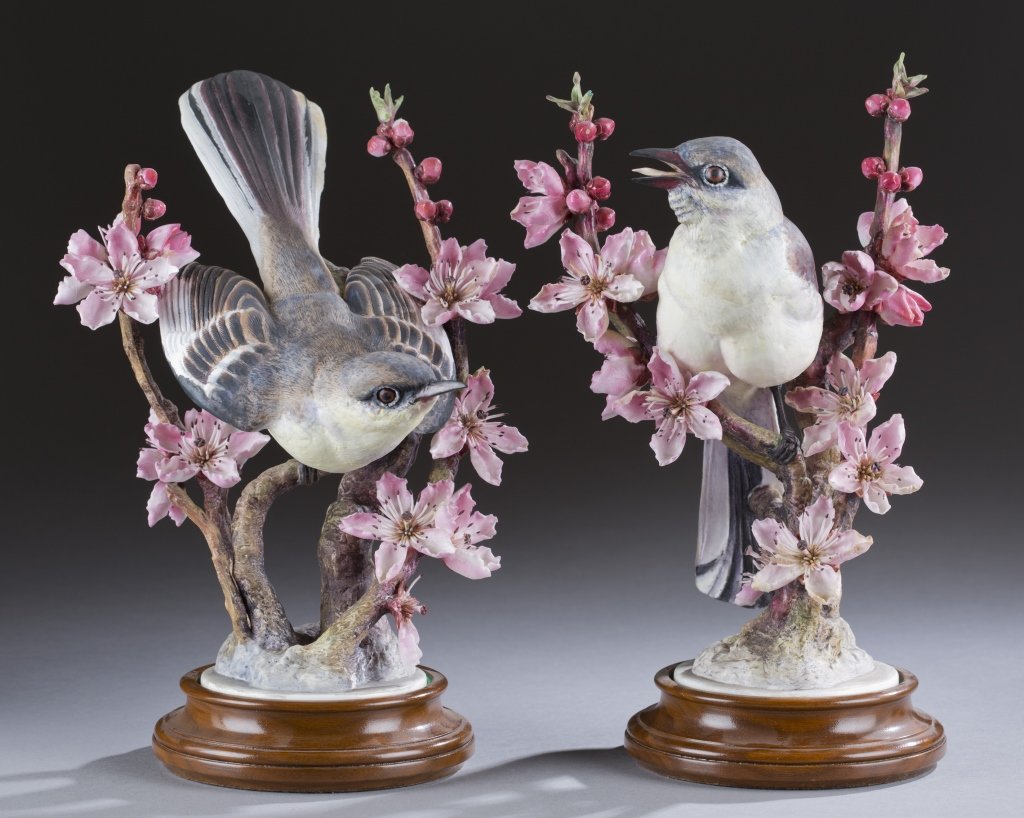 Royal Worcester, Dorothy Doughty, Mockingbirds.: A pair of Royal Worcester porcelain Mockingbirds by Dorothy Doughty . 20th century. Gray birds perched on pink blossoming branches with berries. With wood bases. Marked on bottom. 12"h.