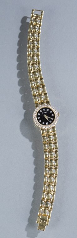 Piaget ladies 1ct diamond and 18kt gold watch.: A Piaget Quartz ladies 1ct diamond and 18kt gold watch. Having a bezel with 25 round brilliant cut diamonds and a face with 12 round brilliant cut diamonds resting on a black dial reading Piaget Swiss