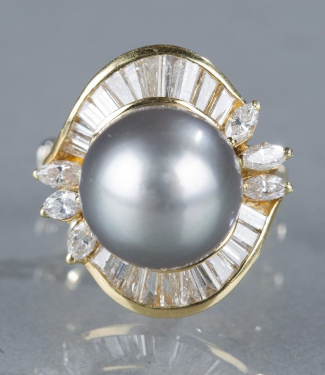 Single Tahitian pearl and diamond 18kt gold ring.: A single Tahitian pearl and diamond ring. Having a 12.55 mm blue grey Tahitian round pearl set in 18kt yellow gold with an estimated 0.75 ct of marquise and tapered baguette diamonds with an average c