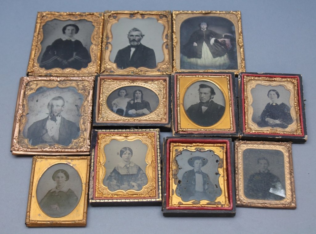 ~31 Ambrotype portraits.: [Ambrotypes/Portraits]. About 31 Ambrotype portraits of men, women, children & families, incl. African American woman holding white child, all framed in half cases. Half-plate, quarter-plate, Sixth-pl