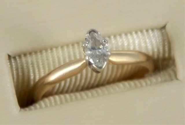 0.24ct marquise cut diamond set: A 0.24ct(6.36 x 3.51 x 2.43) marquise cut diamond set in a 14kt yellow and white gold ring. The diamond having an approximate color of M-N(yellow) and clarity of I3. Marked ADORE 14kt. Size 6. 2 g.