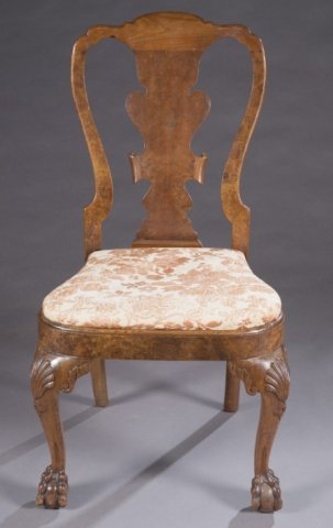 Queen Ann side chair: A Queen Ann side chair. Mid 18th century. Carved yoke, splat and cabriole leg with claw and ball feet in walnut and the stile and seat rail are in burled walnut. 39"h x 21 1/2"w.