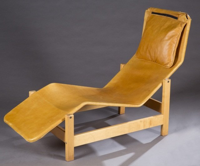 Modern light wood chase lounge.: A modern chaise lounge chair. 2nd half 20th century. Light wood frame with tan leather upholstery and headrest pillow. 35 1/2" x 22 1/2" x 54".