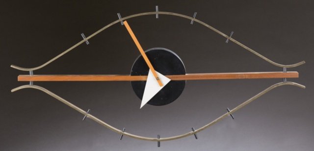George Nelson eye clock.: George Nelson & Associates Eye clock, model 2238. c.1957. Howard Miller Clock Company, made in Germany. Brass, enamel brass and steel, walnut and aluminum. 3"h x 30"w x 14"d.