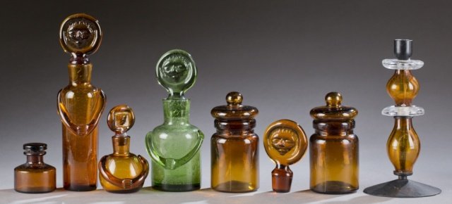 Erik Hoglund decanters & assorted glass: A group of Erik Hoglund and assorted glass. 20th century. ++3 Glass decanters and an extra top. Erik Hoglund. Amber and green glass. Various sizes: 9 3/4" - 4 3/4". ++Candlestick. Erik Hoglund. Amber 