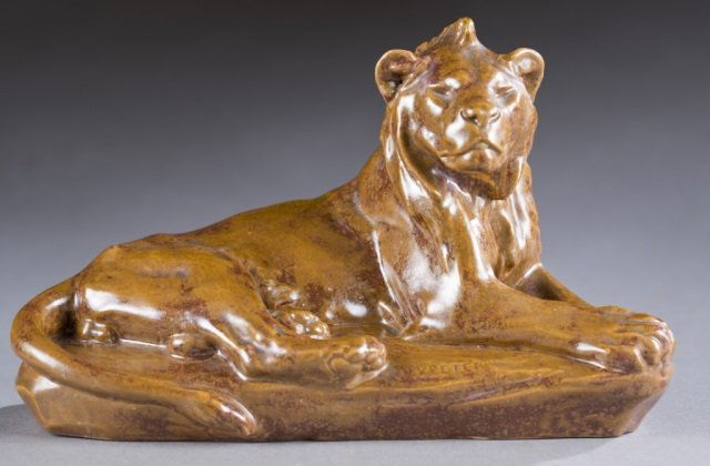 Sevres earthenware model of a lion.: A Sevres earthenware model of a lion. c.1902. Reclining lion in brown crystalline glaze signed V. Peter. Marked with black stamp on bottom. 6 1/2" x 11". Condition: Small area of paint on the back tha