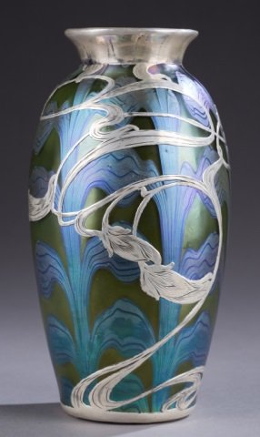 Loetz silver overlay vase.: A Loetz Juno Sterling overlay vase. c.1902. Iridescent green background with iridescent blue wave glass design and Sterling overlay. Monogram E.H.W. on side. 7".