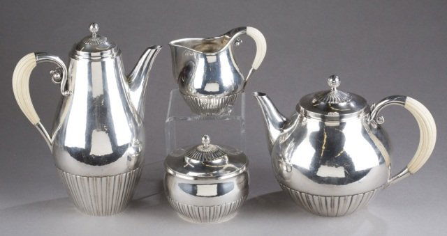 Georg Jensen Sterling 4 piece Tea/Coffee set: A Georg Jensen Sterling Tea & Coffee set with ivory handles, designed by Johan Rohde. c.1945. 4 pieces include: coffee pot, 7 1/2"; teapot, 9 3/4"; creamer pitcher, 4 1/2" & covered sugar bowl, 4 1/4"