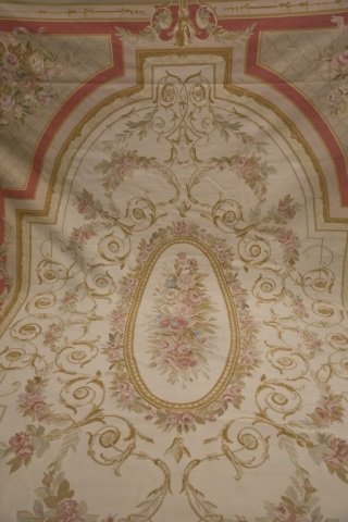 Aubusson room size rug.: An Aubusson room size rug. Second half 20th century. Large central medallion with floral design with red and light pink perimeter. 11'4" x 15'6".