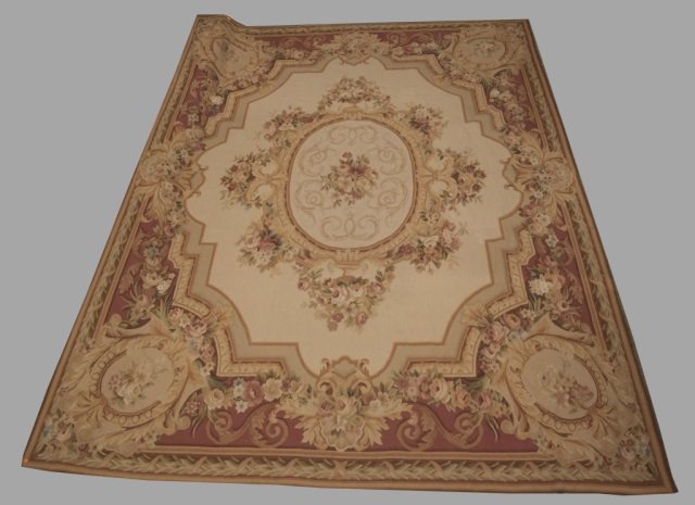 Aubusson style mauve and gold carpet.: An Aubusson style carpet. Second half 20th century. Central floral medallion surrounded by four corner floral medallions in mauve and gold hues. 10' x 7 1/2'.