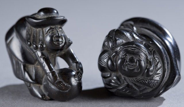 Two Japanese ebony netsuke – Daruma and a Dutchman: Two Japanese ebony netsuke. 1st half 19th century. ++ Daruma emerging from a bag, with 1 himotoshi on back, and 1 on bottom. 3.6cm. ++ A Dutchman in hat leaning over and grabbing engorged testicles. 3