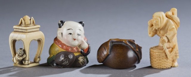 A group of four Japanese Netsuke.: A group of four Japanese Netsuke. ++ A boxwood carved peach with 3 leaves. 1st half 20th century. 4.4cm. ++ Ivory table with Shoki’s hat on it and oni underneath. Leg of oni missing. 5.13cm h. ++ Te