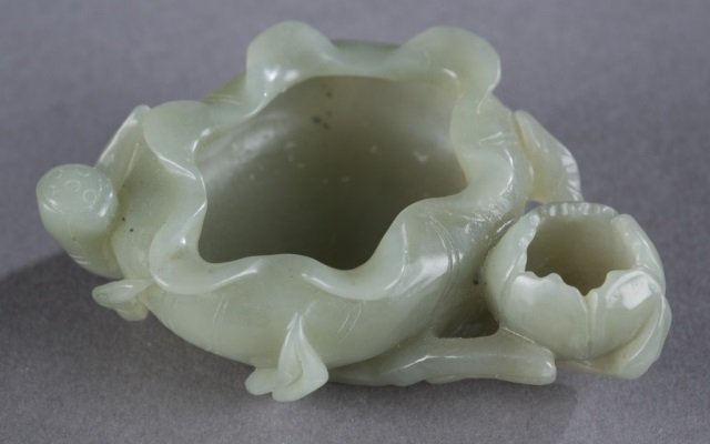 A Chinese celadon brush washer.: A Chinese celadon jade brush washer in the form of an open lotus. 3 1/2".