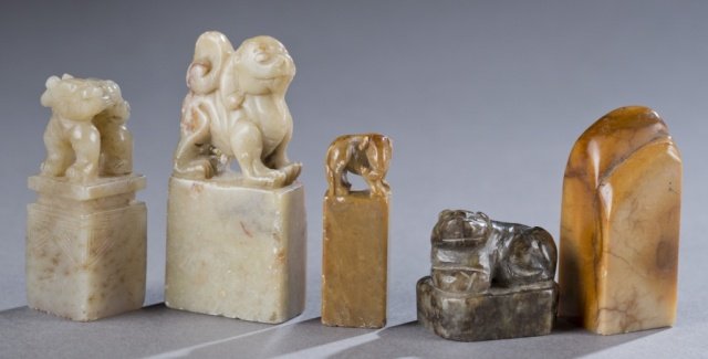 Ching Dynasty Soapstone seals.: A group of 5 Ching Dynasty Soapstone seals. ++Carved with a Foo dog on top. Bottom carved with lines.2 1/4". ++Carved with Foo dog. Bottom carved with writing. 1 1/4". ++Carved with landscape. Bottom 