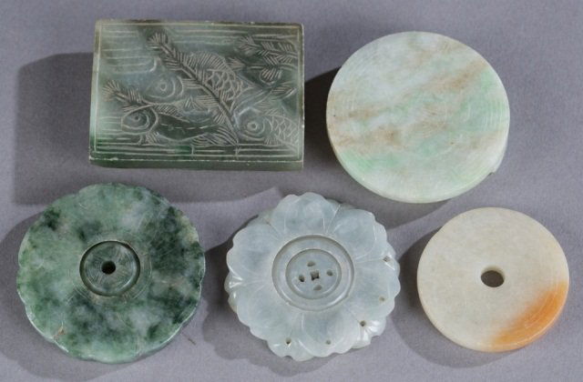 Ching Dynasty Jadeite plaques.: A group of 5 Ching Dynasty Jadeite plaques. ++Carved with fish design and a pair of feet on the bottom. 2 3/4" x 2". ++Craved with a geometrical design and a pair of feet on the bottom. 2 1/2"diam. ++