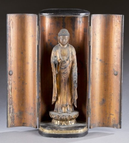 East-Asian wooden Buddhist shrine.: A wooden East-Asian Buddhist shrine. 19th/20th century. Wooden carved Buddha in Vitarka stance atop a lotus flower. Gilded and enclosed in wooden case. 15" x 6 1/2". Condition: Missing fingers on righ