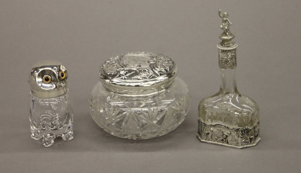 Group of molded glass.: A group of crystal incl: antique English owl, ink bottle with Sterling top and glass eyes, cut crystal dresser jar with Sterling top, & perfume bottle with mounts.