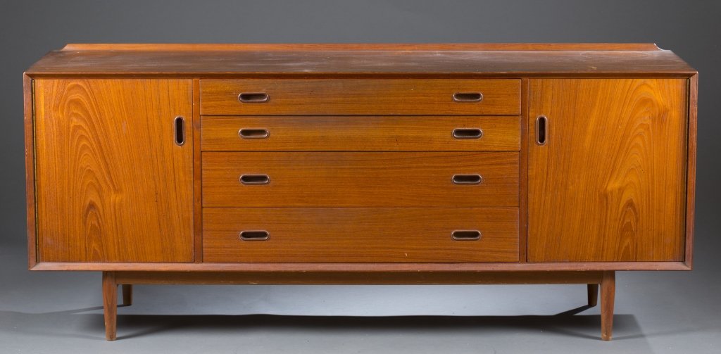 Arne Vodder sideboard.: An Arne Vodder sideboard. Mid 20th century. Made by Sibast Furniture of Denmark. 4 drawers in the center flanked by a door on each side. 30"h x 72"w x 19.5"