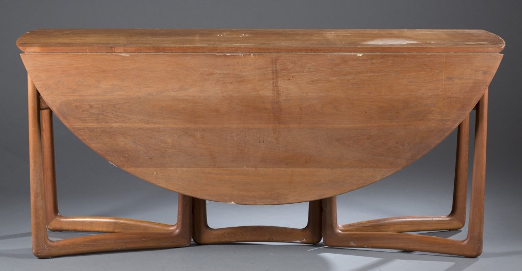 Hvidt and Molgaard-Nielson drop leaf dining table.: A Peter Hvidt and Orla Molgaard-Nielson drop leaf dining table. c.1960s. Made for France and Son of Denmark. Teak and brass. Legs swing out to support the one or both leaves. Closed: 28" x 64" x 18". 