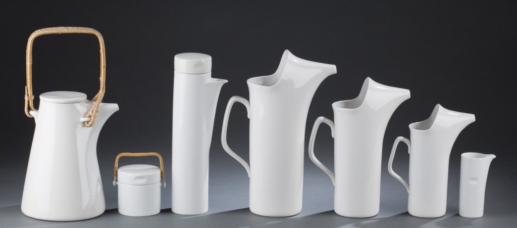 Group of Schmid LaGardo Tackett porcelain: A Schmid LaGardo Tackett tea/coffee service. 1960. ++ White ironstone teapot with rattan handle. On bottom, maker's mark, NKT, SCHMID, OVENPROOF, IRONSTONE, TACKETT, copyright symbol with date 1960. 8