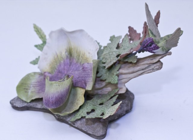 Boehm Hummingbird on orchid.: A Boehm bisque Hummingbird on orchid (400-08). 5"h x 7 1/2"w.