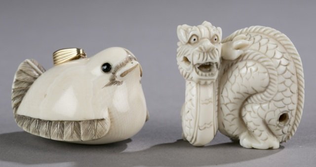 Pair of netsukes.: Pair of netsukes. Bird. 1 1/8" x 1 3/4".++ Dragon. 1 1/2" x 1 1/2".