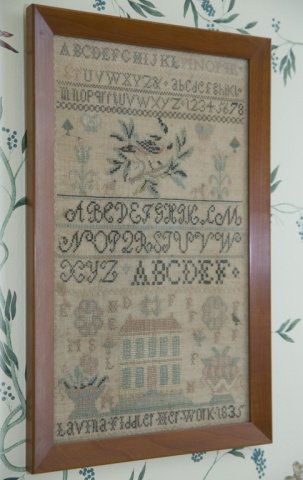 Sampler. 19th century.: Sampler. 19th century. Alphabet, animals and floral designs. Lavina Fiddler. 1835. Wood frame. Frame: 19 1/4" x 12".
