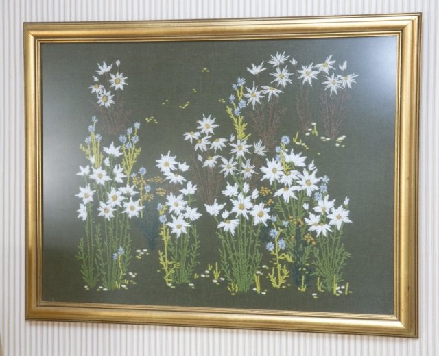 Daisy and wildflower needlepoint on wool.: Daisy and wildflower needlepoint on wool. Gold gilt frame. Frame: 21" x 26 3/4".