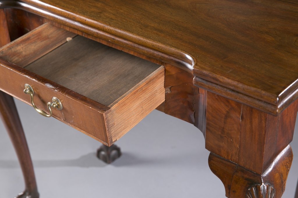 Flip top hardwood card table.: A flip top veneer and hardwood card table. Having cabriole legs with carved shell on knee, ball and claw feet, one drawer with brass pull, and single gate leg. Cracking veneer. 28 1/2"h x 32 3/8"w x 1