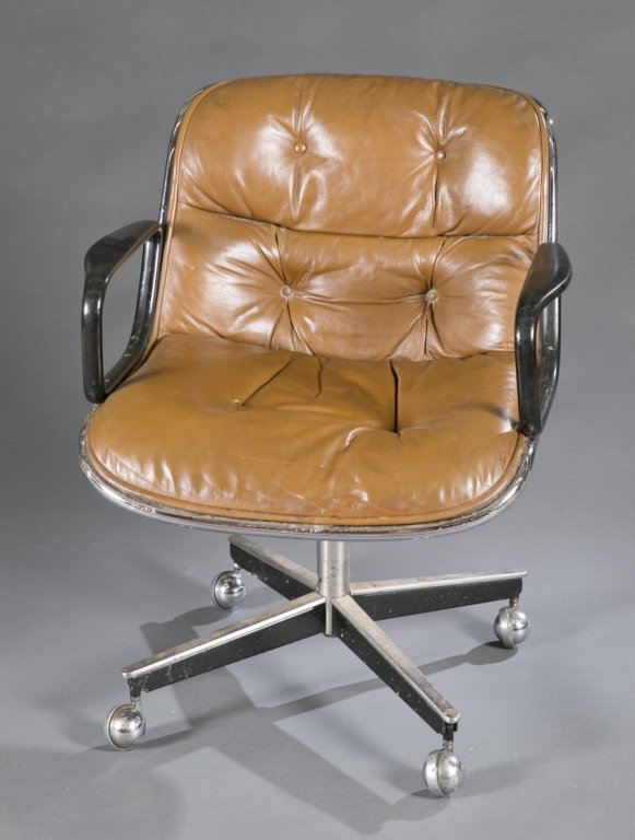 Modern design desk chair with Knoll: A noll office chair designed by Charles Pollock. Brown leather with black arms, on rolling base.