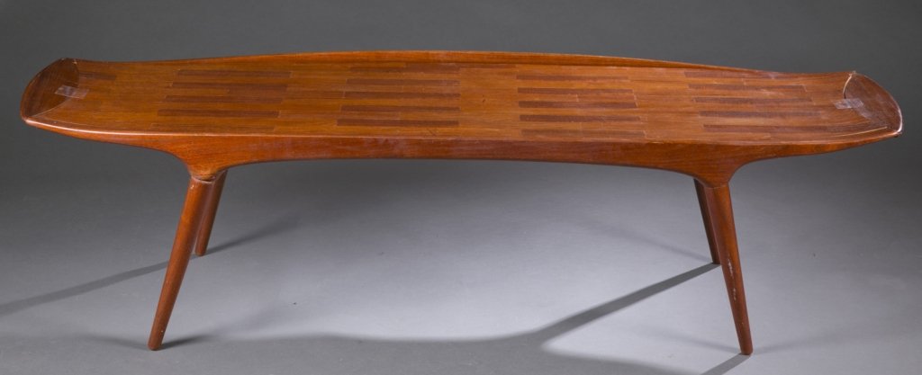 Danish modern oblong coffee table, M&K.: A Mogens Kold teak coffee table. Oblong with rounded ends, on 4 legs One leg needs repair at the joint, ends have been re-attached. 17 1/2" x 62" x 21".