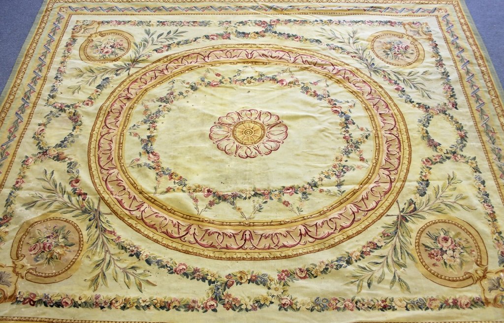 Aubusson carpet: An Aubusson carpet. Swags and garlands with large center medallion and smaller medallions in each corner with a creamy yellow background.