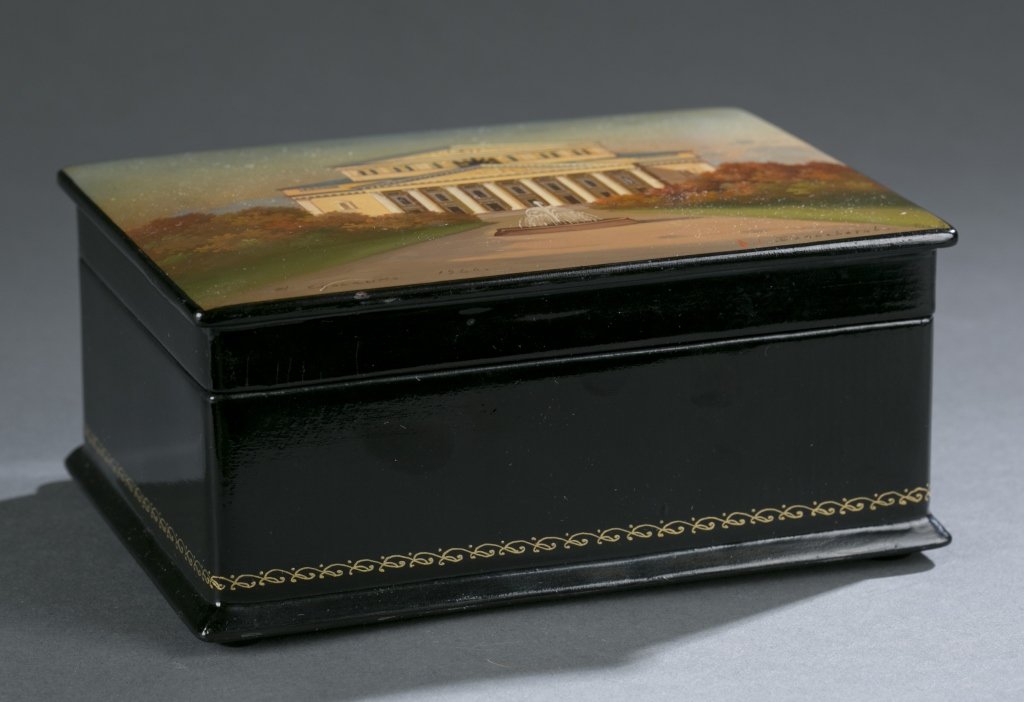 Russian lacquer box with Kirov Ballet building.: A Russian lacquer box with Kirov Ballet building on lid. 1966, Soviet era. Black exterior with gold geometric border around base and a red interior. Signed and dated l.l. of lid and writing on l.r. of
