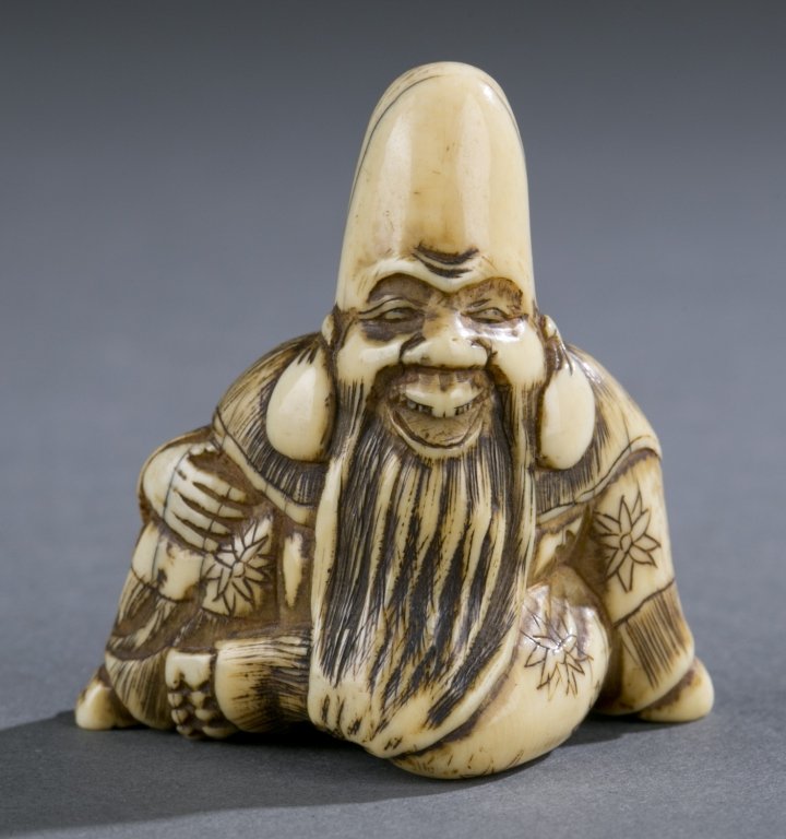 group of three Japanese ivory netsuke. 19th: A group of three Japanese ivory netsuke. 19th century. Unsigned. ++ A seated robed Buddha with elongated head. Himotoshi on back and bottom. 47.74mm. ++ A standing robed Buddha with elongated head. Hi