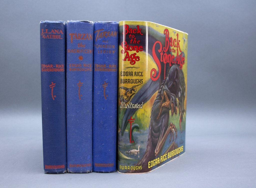 4 Burroughs firsts incl: LLANA OF GATHOL.: [Burroughs, Edgar Rice] 4 First Editions. 8vo. Blue cloth with red lettering, top edges of text blocks red, lacking djs. Corners of covers and spine ends worn. Sunning. ++ LLANA OF GATHOL. Tarzana, CA