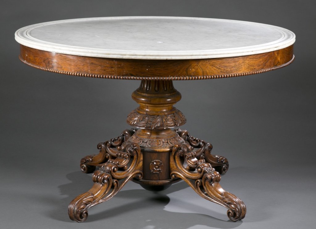 Victorian center table with marble top.: A Victorian center table with a white marble top. Last half 19th century. Probably English. Solid hardwood with carved beading around base of top, carved pedestal base with floral design, Tudor roses,