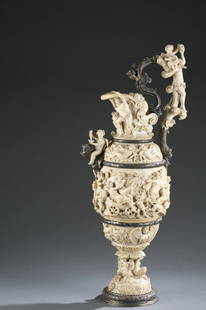 German, 19th c. silver and carved ivory ewer.: A German, 19th century silver and carved ivory ewer. Carved ivory in high relief having figural adornment of a bacchanal scene. With silver and silver gilt bands, base, and handle. Marked on bottom