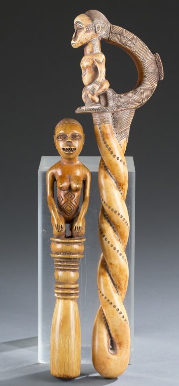 2 African carved ivory scepters.: A group of 2 African carved ivory scepters. ++ A twist carved ivory scepter with male figure on top with semi-circle. 14 1/2"h with 3 3/4"w top. ++ Carved ivory scepter with kneeling nude female figur