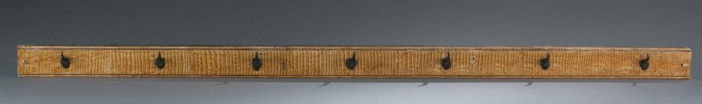 Folk art coat rack.: A folk art coat rack. 19th century. Hand painted with 7 iron hooks. 2 3/4"h x 57 1/2"w.
