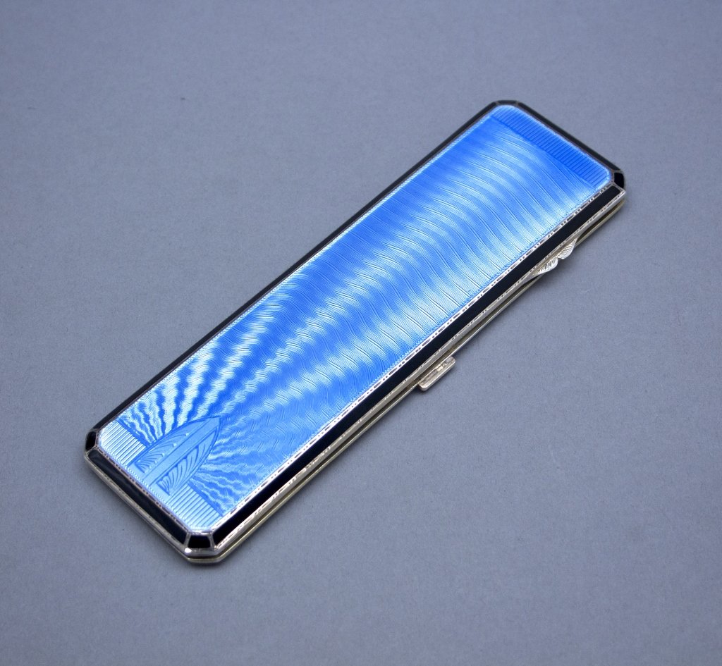 Goldsmith & Silversmith Co eyeglass case: A Goldsmith & Silversmith Co eyeglass case. 1934. Silver gilt and blue enamel Art Deco eyeglass case with architectural and geometric design details and black border on front. On inside, left bottom s