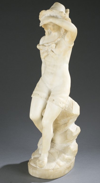 Marble statue of a girl, late 19th/early 20th c.: A marble statue of a girl, late 19th/early 20th century. Girl in a swimming suit, shoes, and hat leaning on a rock. Carved in one piece, unsigned. Replaced finger and chipped hat. 19 3/4"h x 6 1/2"w x
